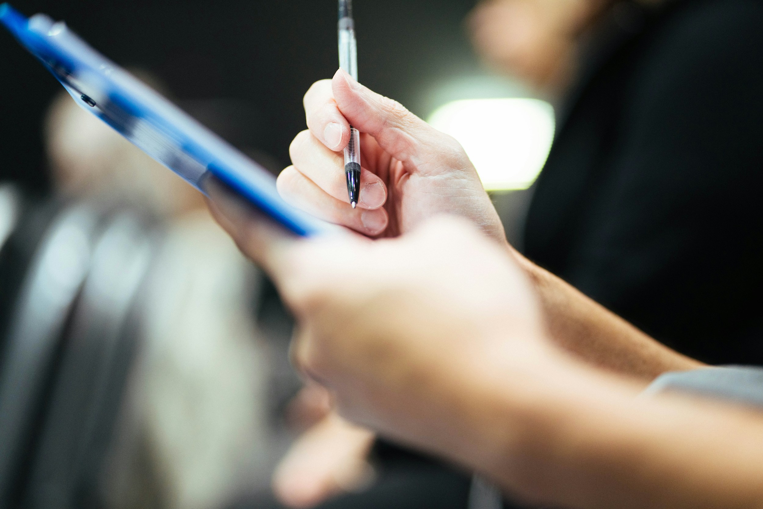 Close-up of a hand completing a written health assessment